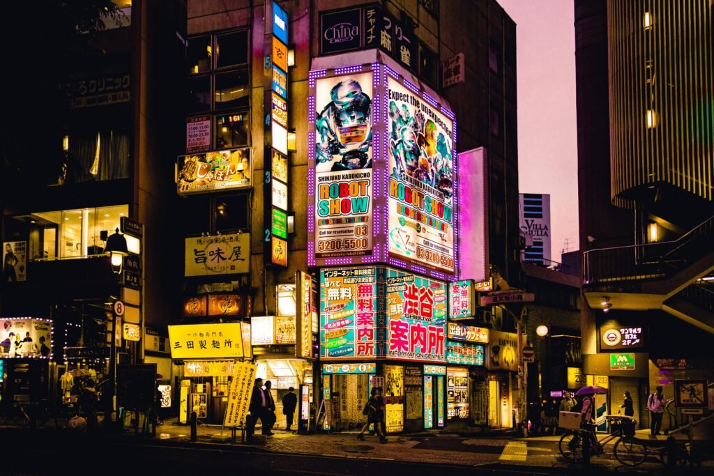 Explore the vibrant nightlife of Shinjuku, Tokyo with colorful neon signs illuminating the bustling streets.